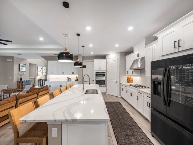 a large kitchen with lots of counter space and stainless steel appliances