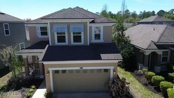 a aerial view of a house with a yard