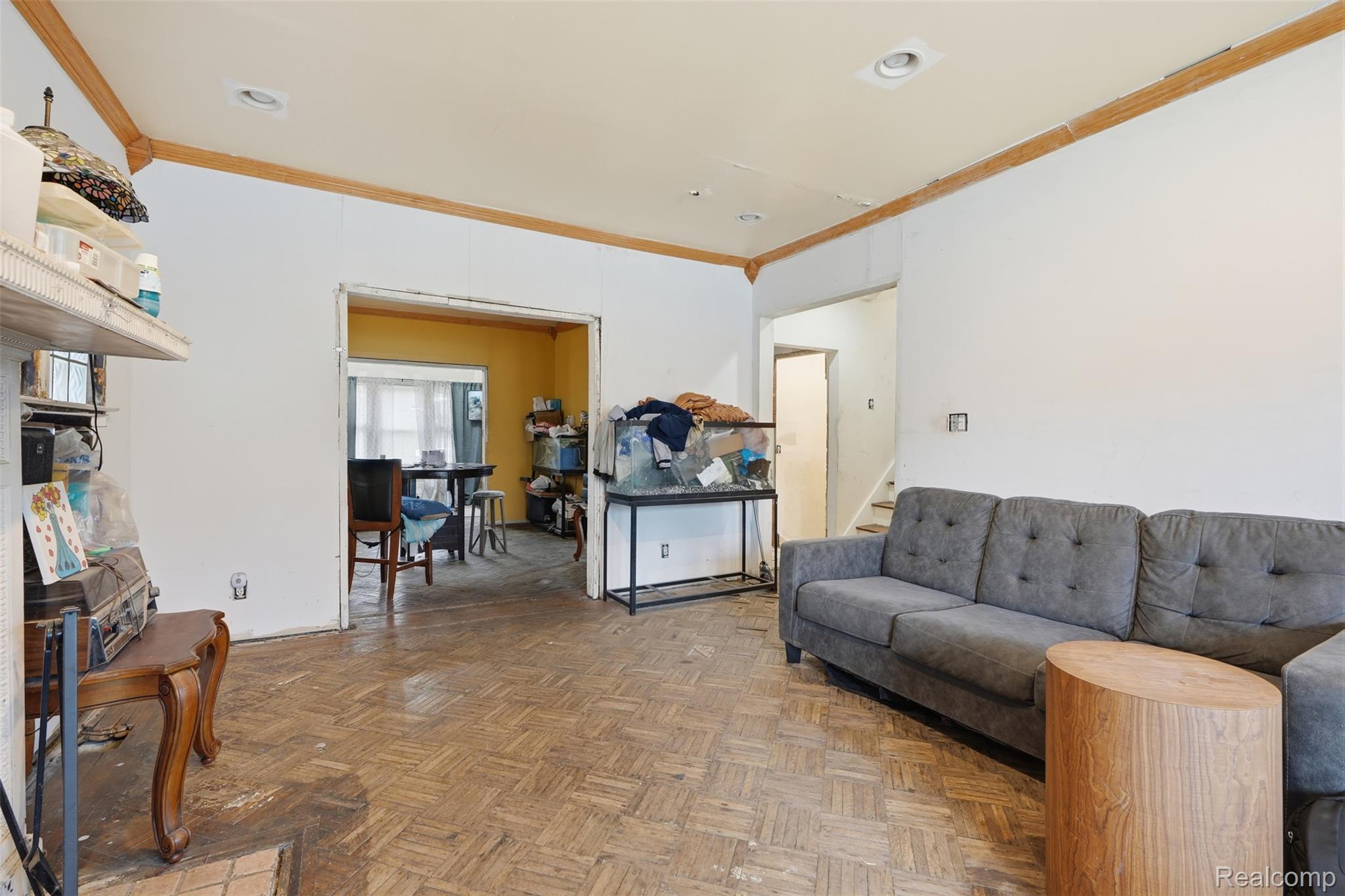 2500 Atkinson Street Detroit, MI 48206 - Photo 4 of 21 Living room featuring parquet flooring, ornamental molding, and recessed lighting