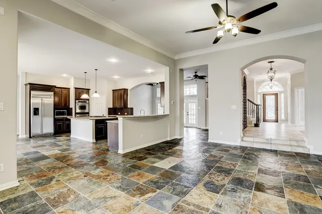 a kitchen with kitchen island granite countertop a sink stove and refrigerator