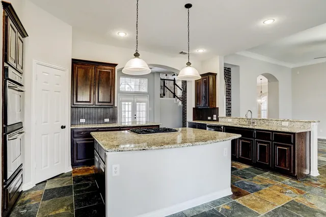 a kitchen with stainless steel appliances granite countertop stove a sink a refrigerator and a stove