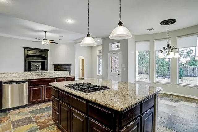 en view interior of a house with a chandelier fan and windows