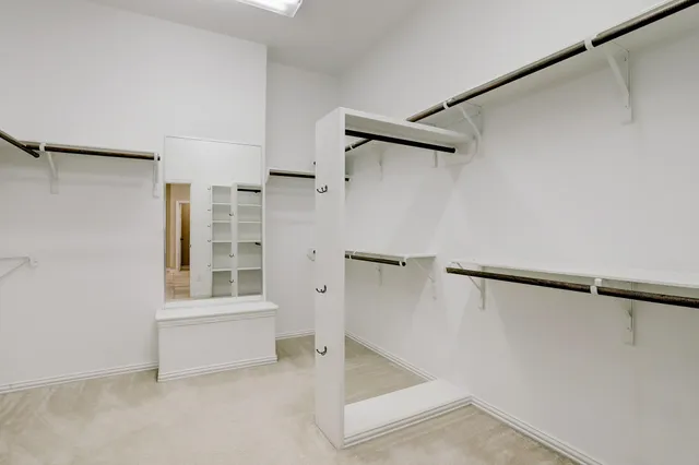 an empty room with closet and a ceiling fan