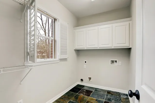 a view of a patio with a table and chairs and floor to ceiling window