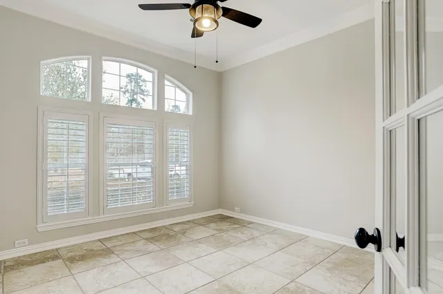 a view of a livingroom with a chandelier and wooden floor