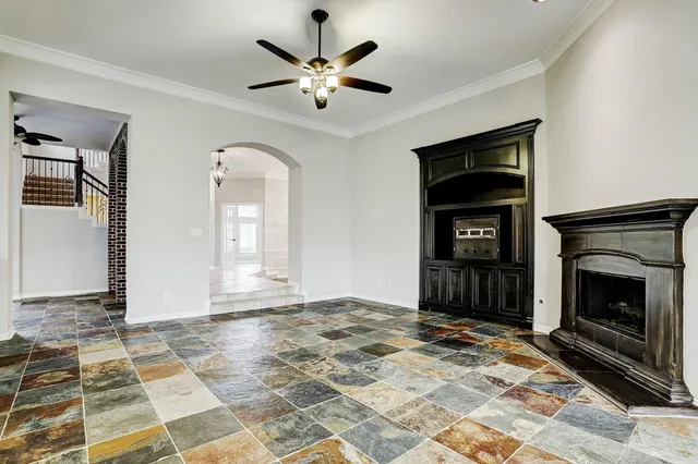 a view of an empty room with exposed radiator and fireplace