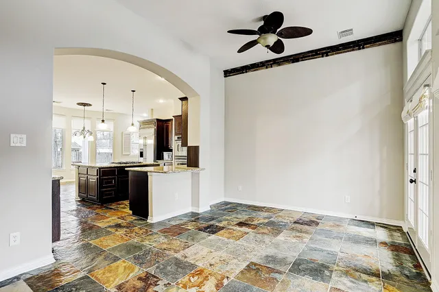 a view of a kitchen with a sink and a refrigerator