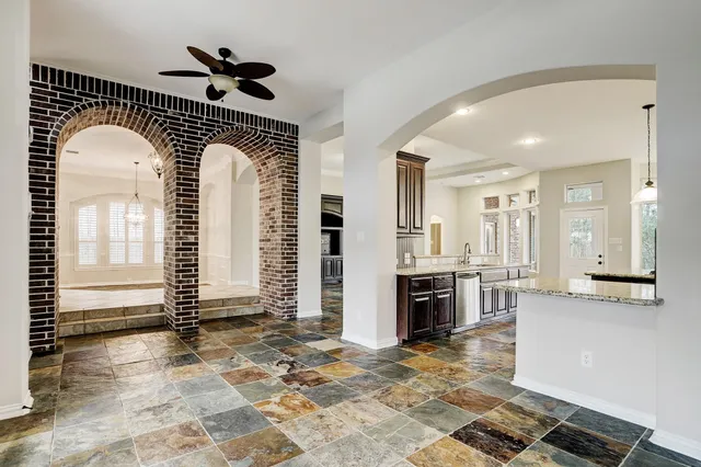a view of kitchen with refrigerator and cabinets