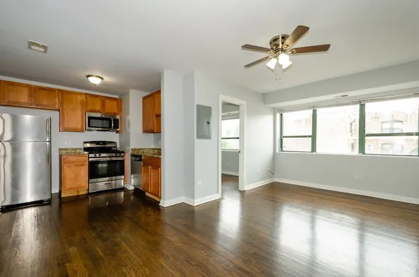 a kitchen with a refrigerator and a stove top oven
