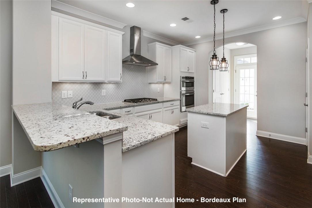 10175 Rainier Trail Drive Northwest Huntersville, NC 28078 - Photo 8 of 18 a kitchen with a sink a counter space appliances and cabinets