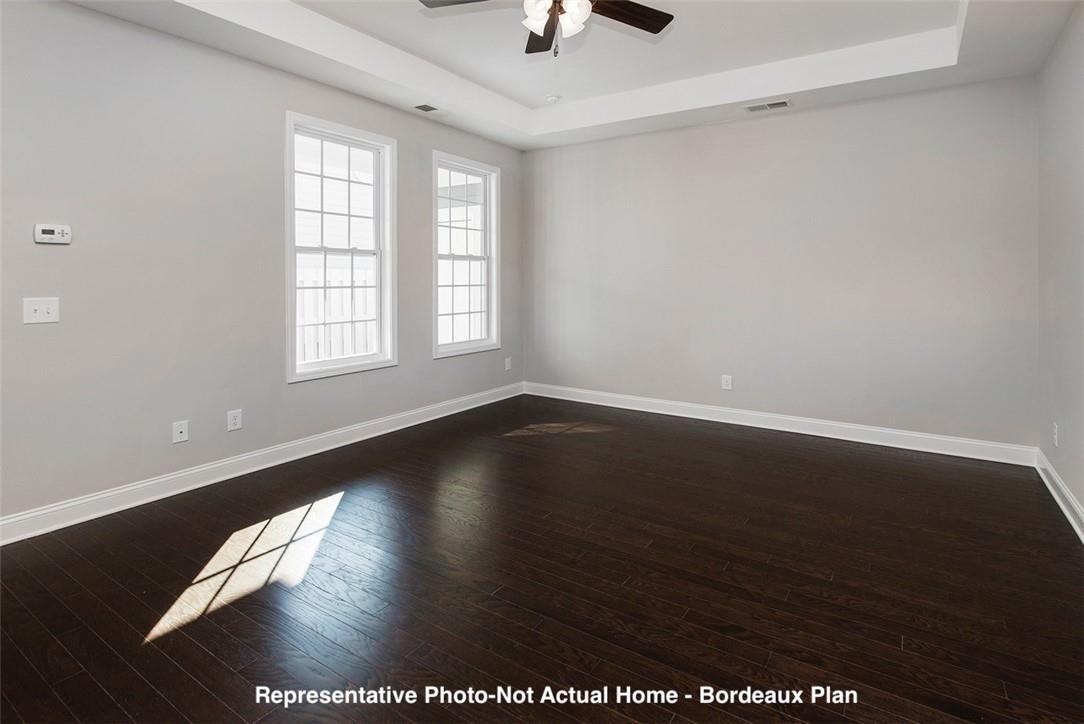 10175 Rainier Trail Drive Northwest Huntersville, NC 28078 - Photo 10 of 18 an empty room with wooden floor chandelier fan and windows
