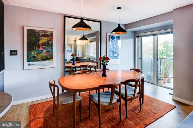 a dining room with furniture and wooden floor
