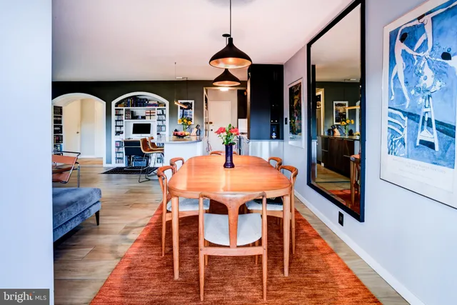 a dining room with furniture and wooden floor