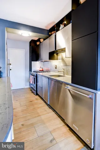 a kitchen with stainless steel appliances granite countertop a stove and a sink