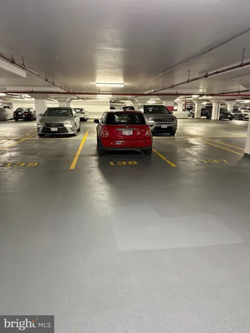 a view of parking garage with cars parked
