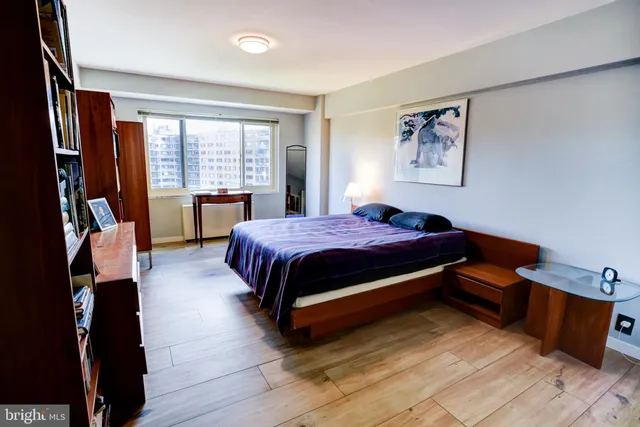 a bedroom with a bed and a book shelf
