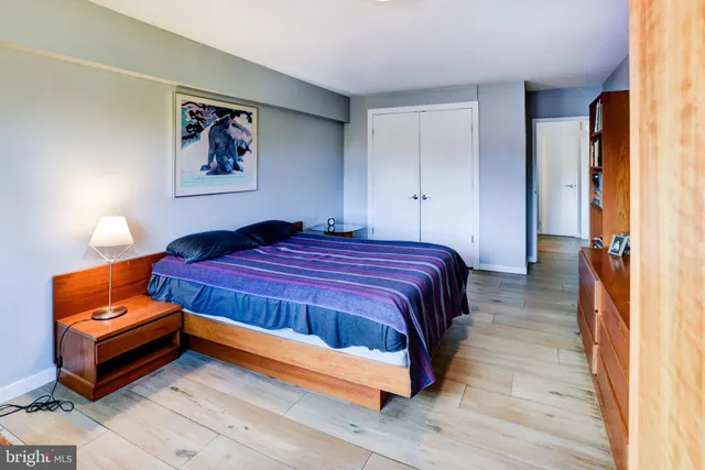 a bathroom with a sink a toilet a window and shower