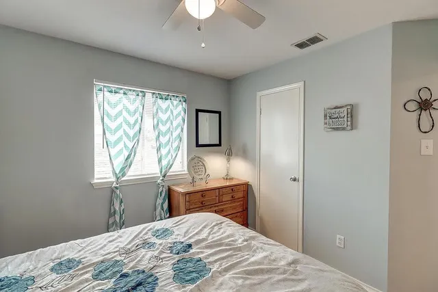 a bedroom with a bed and a window