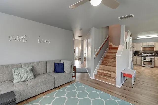 a living room with furniture and stairs
