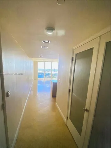 a view of hallway with stainless steel appliances