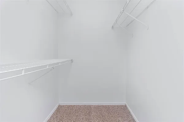 an empty room with a chandelier fan