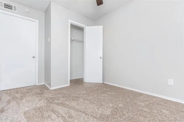 an empty room with a empty space and windows