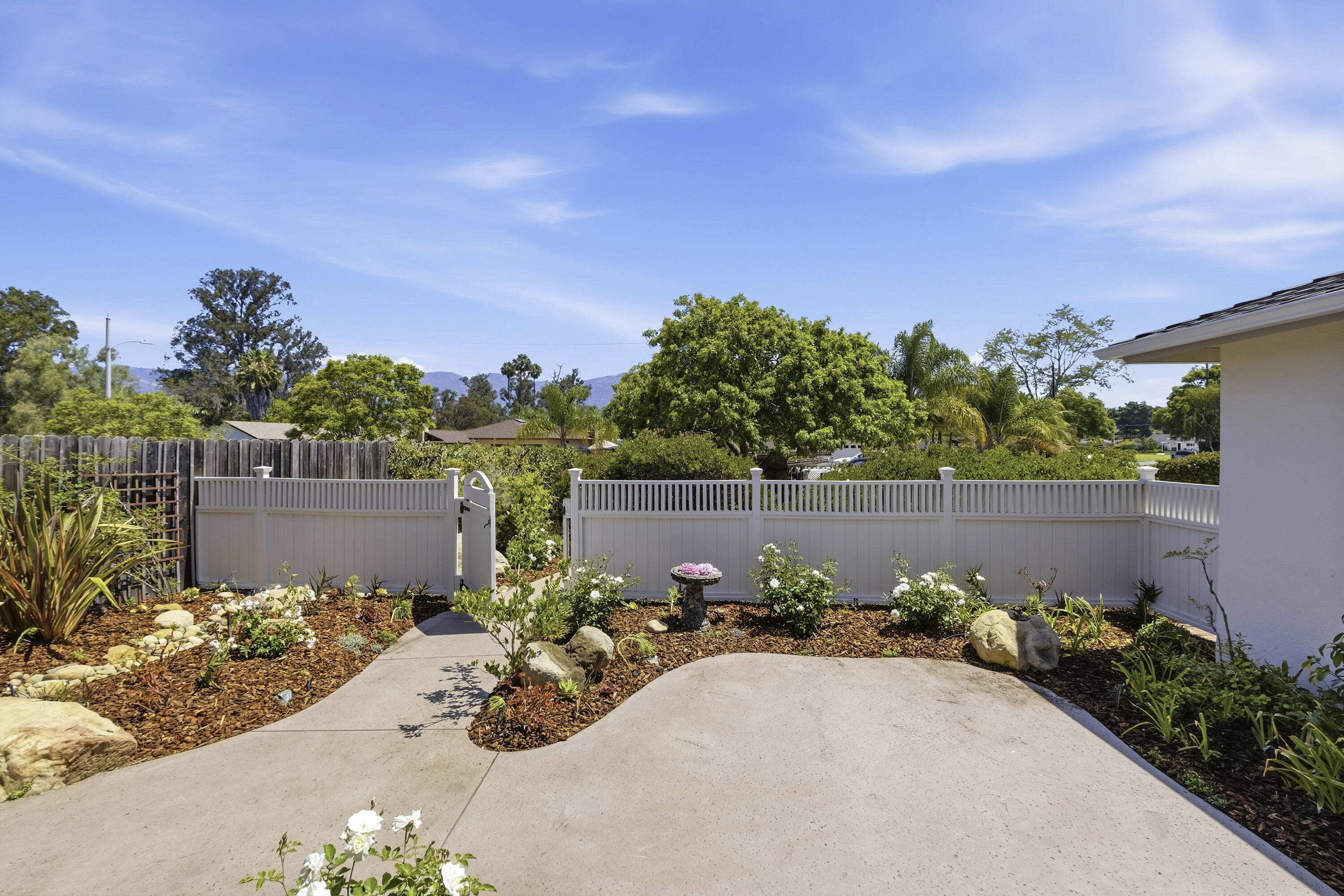 529 Via Rueda Santa Barbara, CA 93110 - Photo 6 of 34 a view of a garden with a bench in front of it