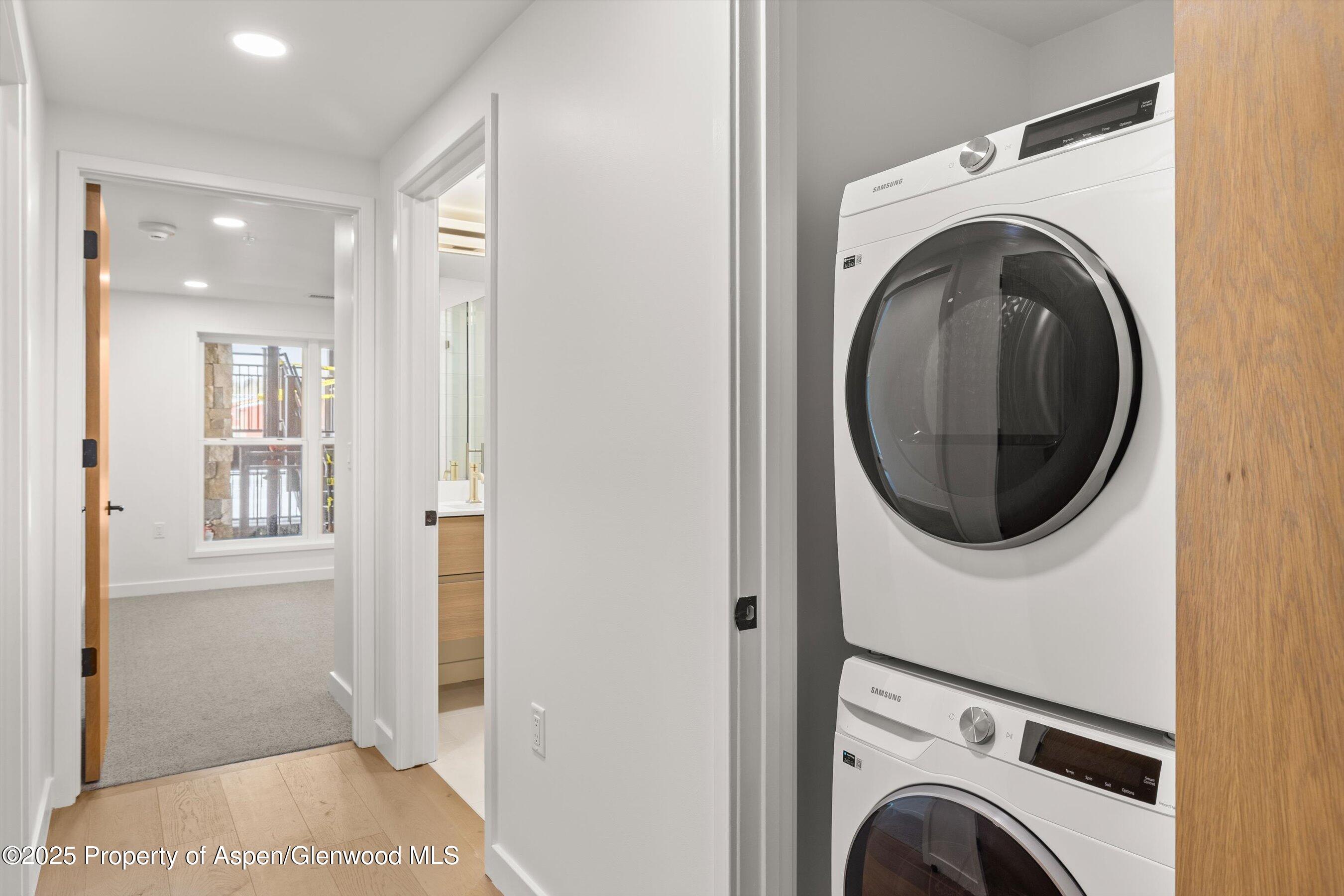 360 Wood Road, Unit 503 Snowmass Village, CO 81615 - Photo 12 of 22 a view of a hallway with washer and dryer