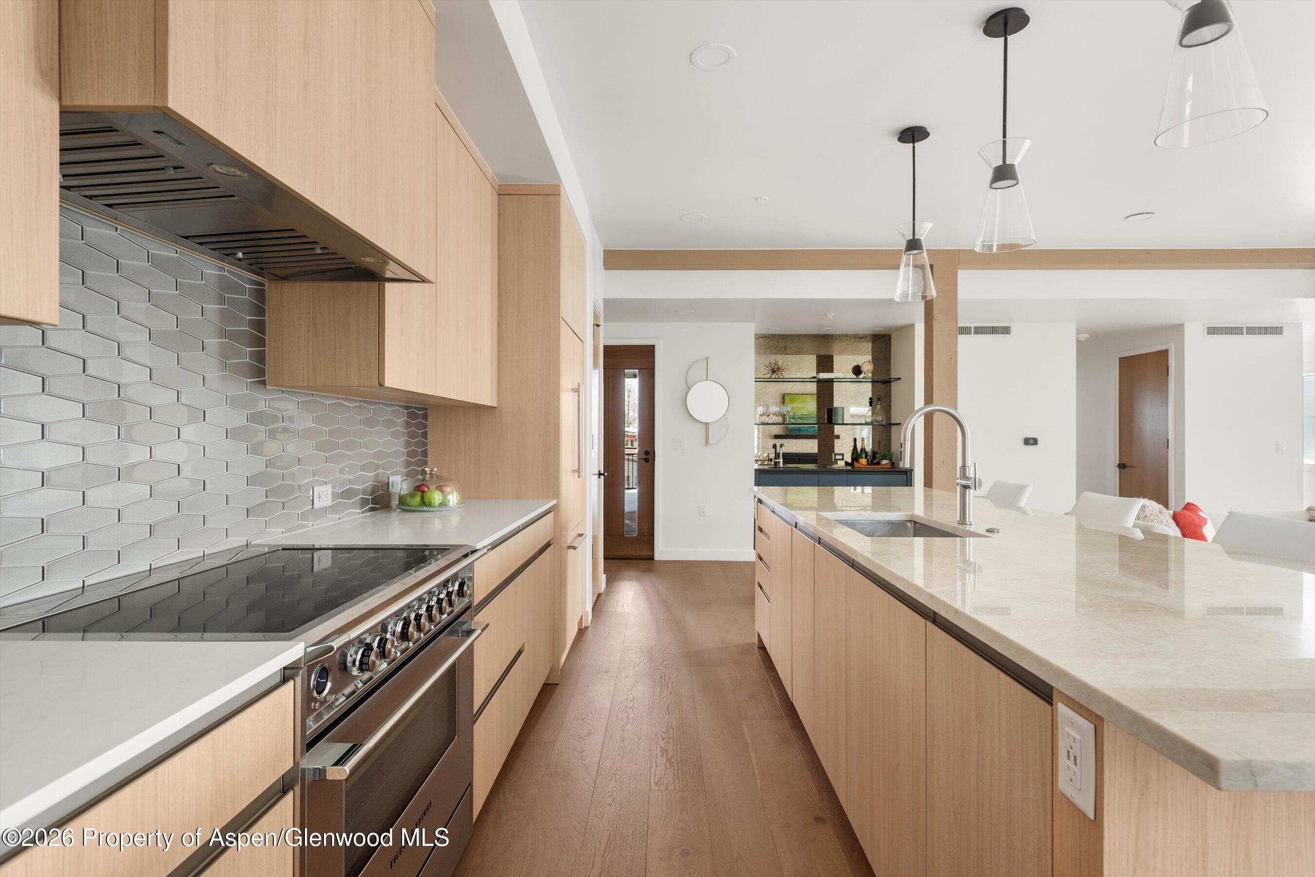 360 Wood Road, Unit 503 Snowmass Village, CO 81615 - Photo 7 of 22 a kitchen with sink stove and cabinets