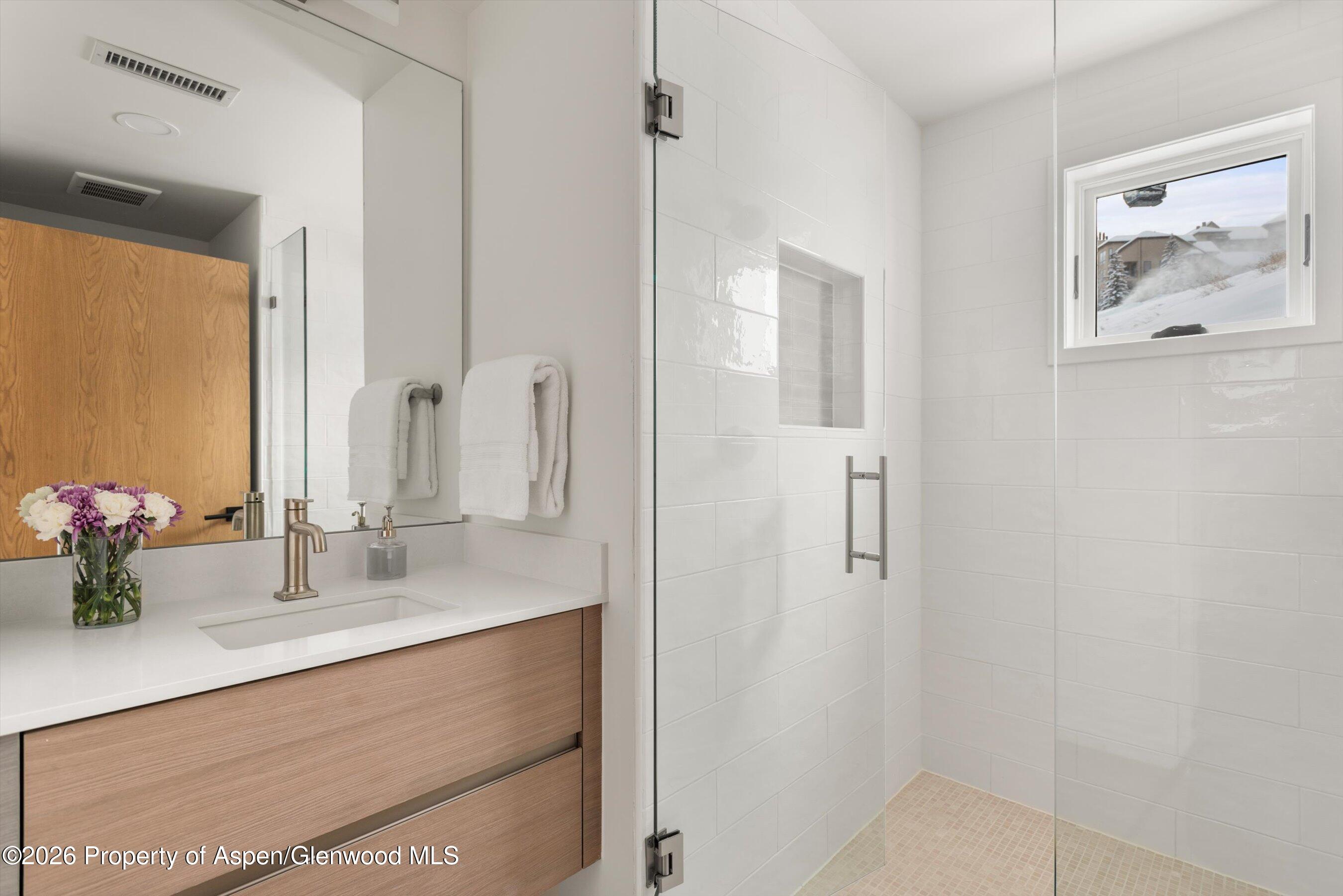 360 Wood Road, Unit 503 Snowmass Village, CO 81615 - Photo 9 of 22 a bathroom with a sink vanity and a mirror