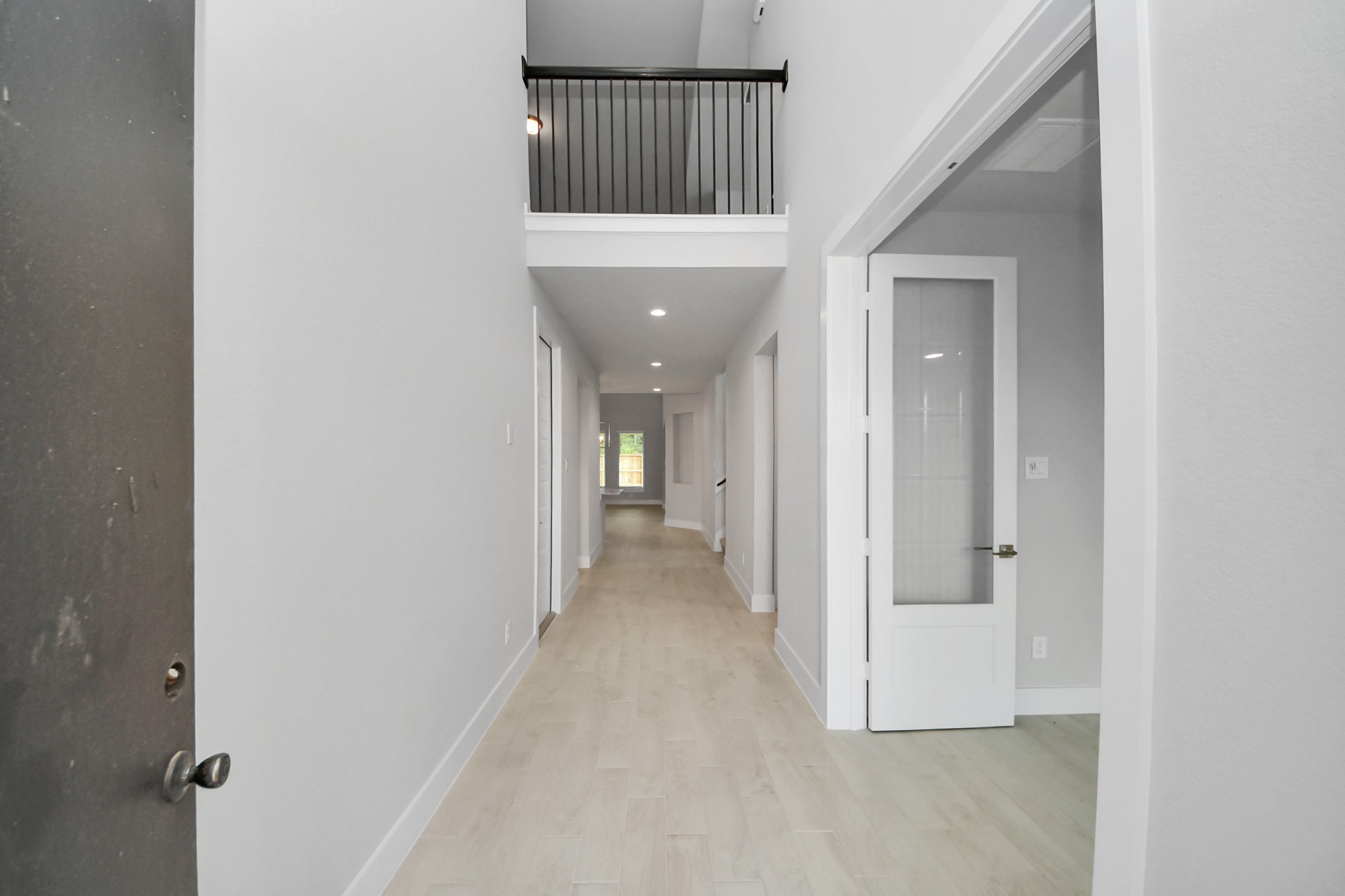 3043 Native Spg Drive Spring, TX 77373 - Photo 6 of 45 As you step into the threshold of this luxurious home, you'll soon be welcomed by an elegant glass door (to be installed). Inside, soaring ceilings amplify the spaciousness, while the refined wood-look tile flooring and oversized baseboards exude sophistication and charm.