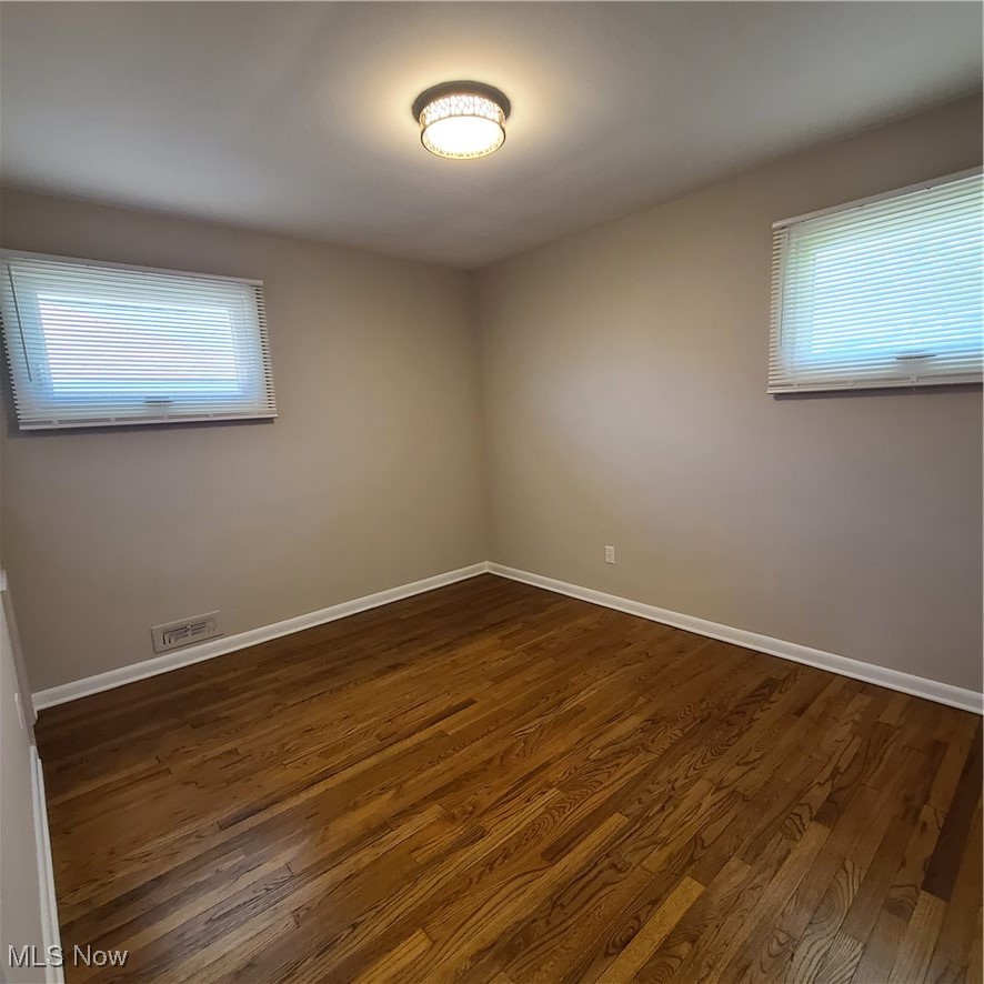 12204 Grannis Road Garfield Heights, OH 44125 - Photo 8 of 22 bedroom #1 features refinished hardwood flooring and fresh paint