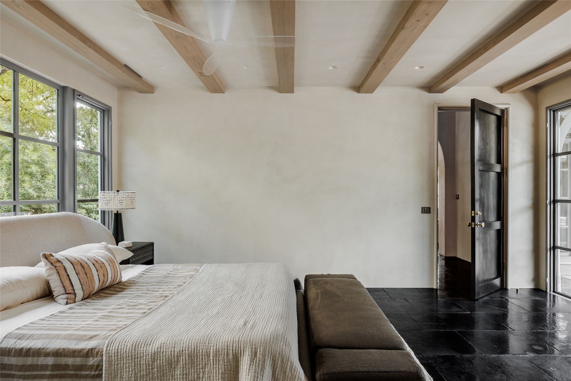 2600 Tanglewood Trail Austin, TX 78703 - Photo 17 of 35 a bedroom with a bed and wooden floor