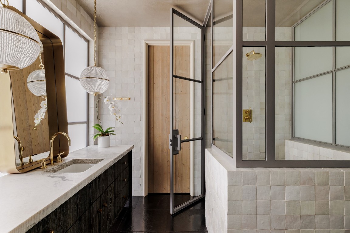 2600 Tanglewood Trail Austin, TX 78703 - Photo 19 of 35 a bathroom with a double vanity sink and mirror