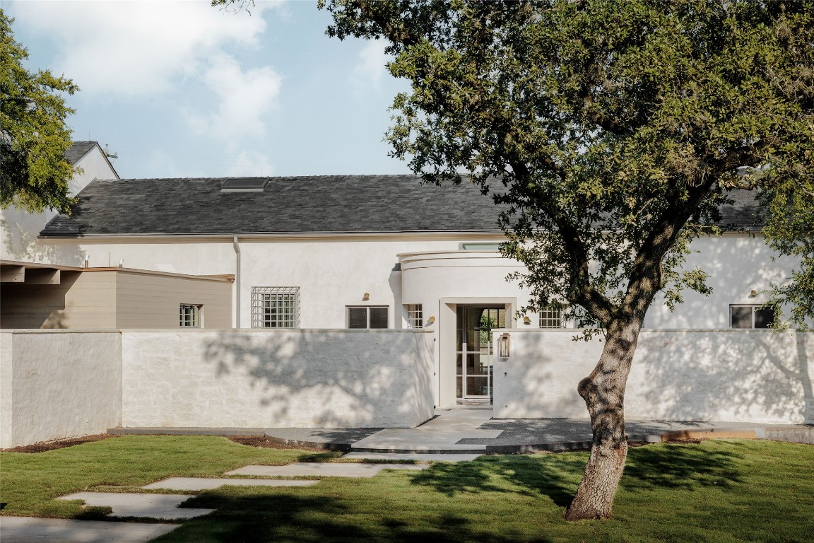 2600 Tanglewood Trail Austin, TX 78703 - Photo 2 of 35 a front view of a house with a yard and garage
