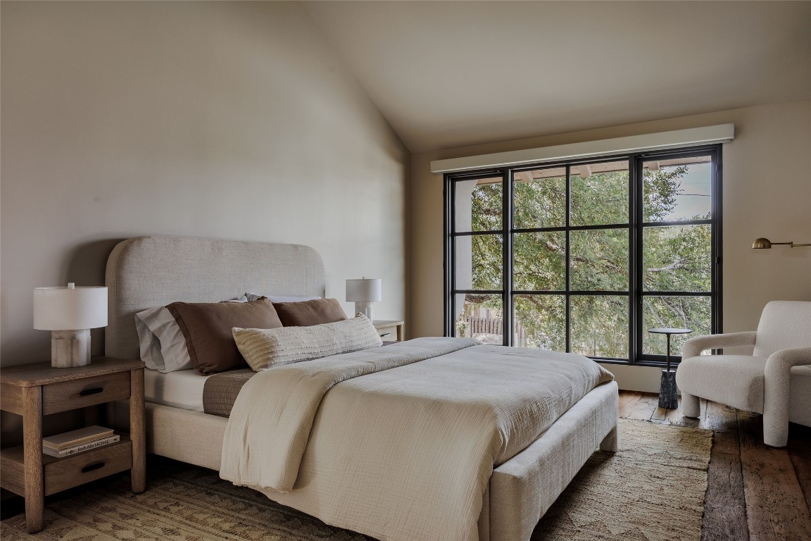 2600 Tanglewood Trail Austin, TX 78703 - Photo 25 of 35 a bedroom with a bed couch and a large window
