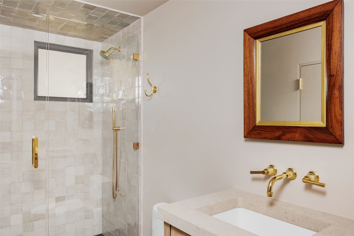 2600 Tanglewood Trail Austin, TX 78703 - Photo 26 of 35 a bathroom with a sink a mirror and shower