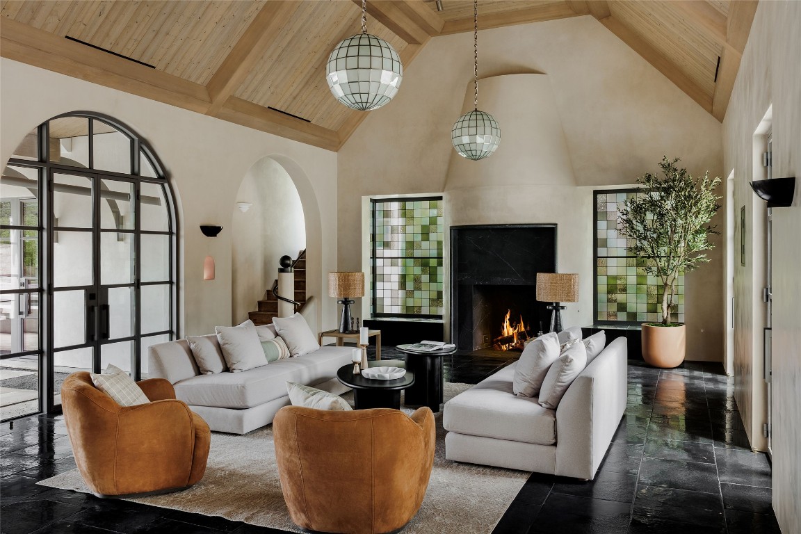 2600 Tanglewood Trail Austin, TX 78703 - Photo 5 of 35 a living room with furniture a fireplace and a chandelier