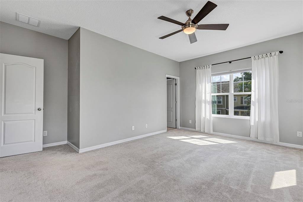 7644 Ripplepointe Way Windermere, FL 34786 - Photo 24 of 52 a view of a livingroom with a ceiling fan and window