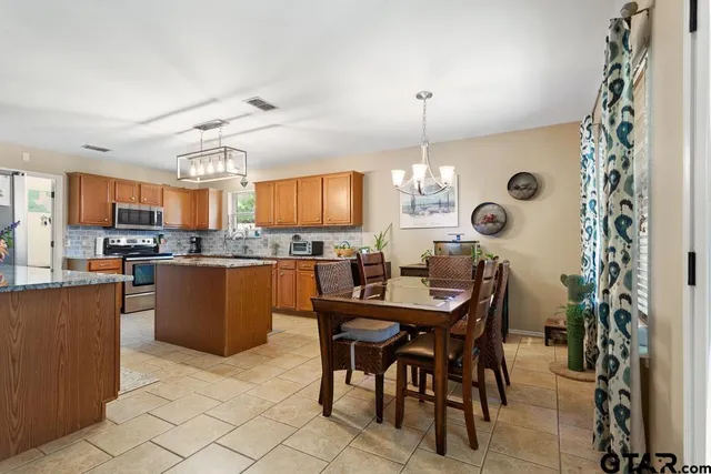 a large kitchen with a table and chairs in it
