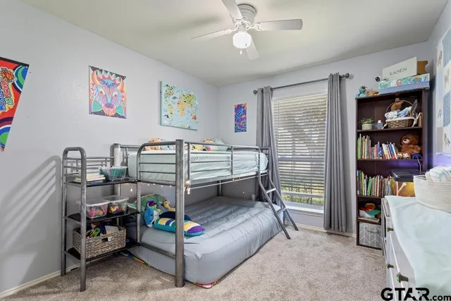 a bedroom with bed and a wine shelf