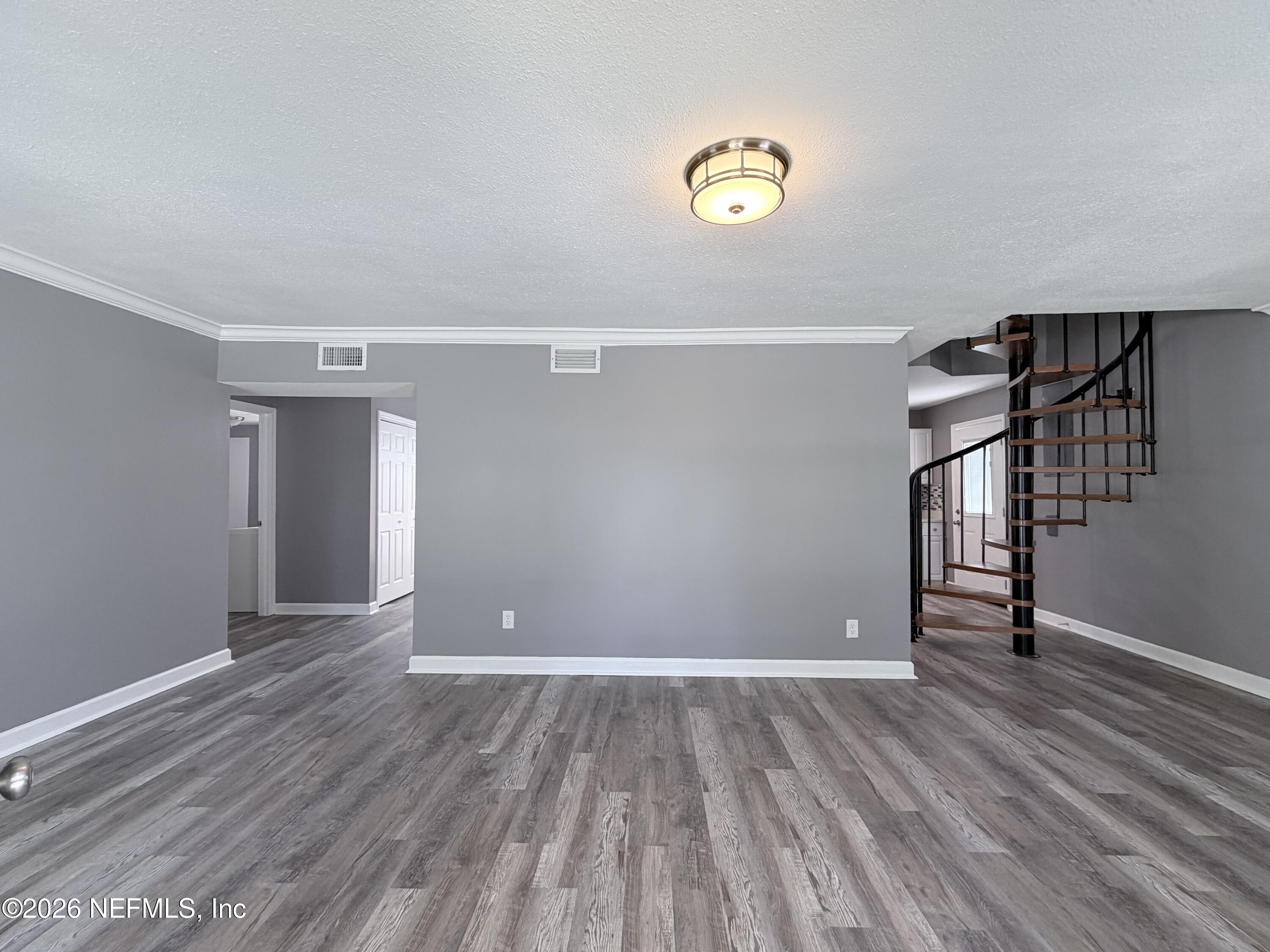 5336 Cruz Road Jacksonville, FL 32207 - Photo 6 of 29 a view of empty room with wooden floor