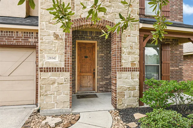 a front view of a building with a garden