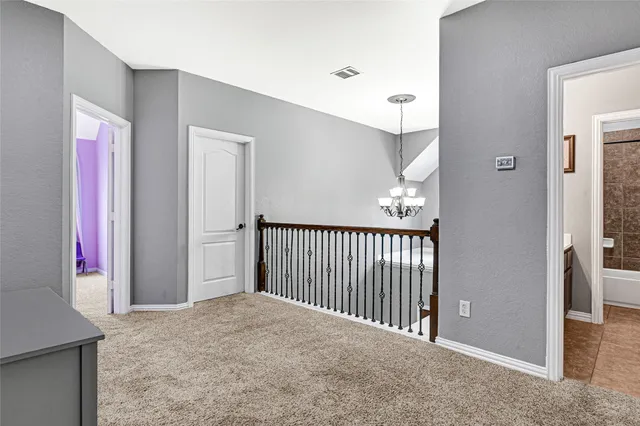 a view of a hallway view with staircase