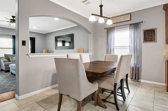 a view of a dining room with furniture and a chandelier