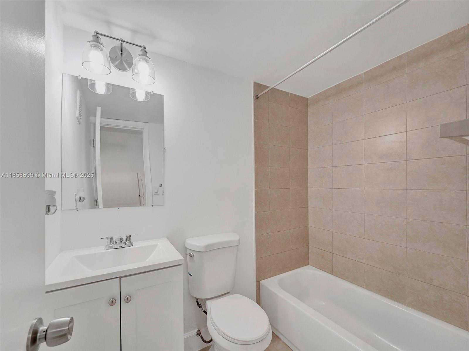 14190 West Dixie Highway, Unit 11 North Miami, FL 33161 - Photo 11 of 21 a bathroom with a sink a toilet and shower