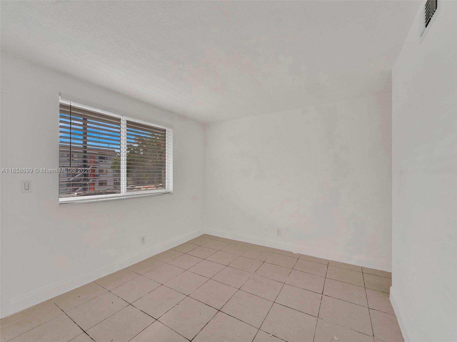 14190 West Dixie Highway, Unit 11 North Miami, FL 33161 - Photo 17 of 21 an empty room with windows