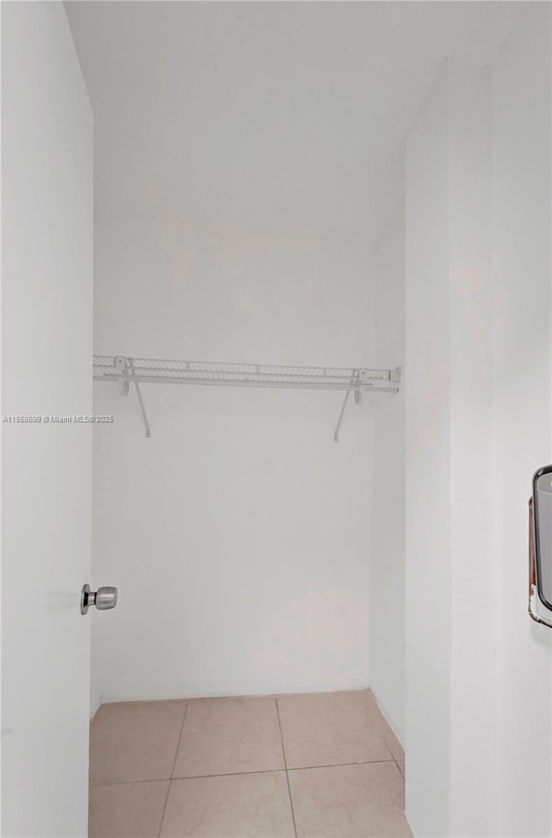 14190 West Dixie Highway, Unit 11 North Miami, FL 33161 - Photo 9 of 21 a view of walk in closet with clothes