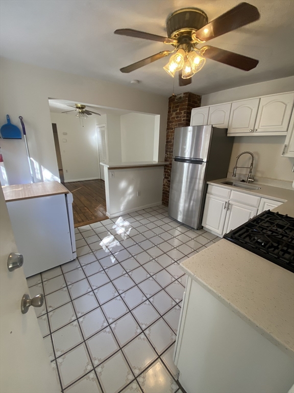 51 School Street, Unit 1 Boston, MA 02129 - Photo 11 of 11 a kitchen with stainless steel appliances granite countertop a sink a stove a refrigerator cabinets and chairs