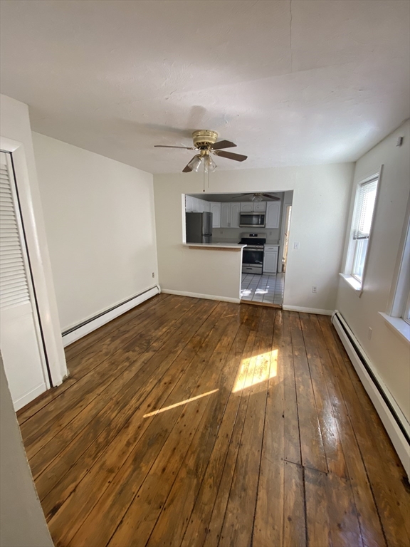 51 School Street, Unit 1 Boston, MA 02129 - Photo 3 of 11 wooden floor in an empty room with a window